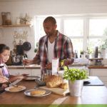 Family prepares breakfast in kitchen.