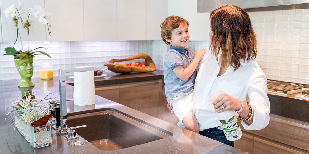 Mother cleaning kitchen with son